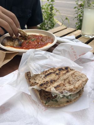 Pita falafel with whole wheat bread and hummus shakshuka bowl at Hummus Bar Vegetarian in Budapest