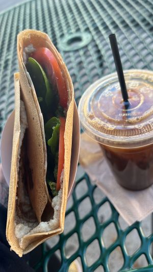 Cheronne crepe with vegan cheese and pesto added, and soy milk cold brew  at Holy Crepes! in New Orleans