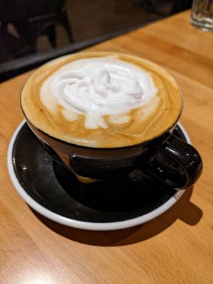 Hazelnut oat milk latte with coconut whip at Snakes & Lattes - Bloor St in Toronto