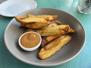 Fried potatoes with black garlic sauce  at Avit in Athens
