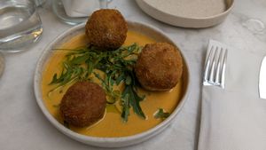 Arancini bacon v.egg, hollandaise, herb oil at Avit in Athens