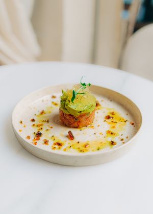Beef tomato tartar with avocado mousse, crispy caramel black sesame seed, tomato pearls at Avit in Athens