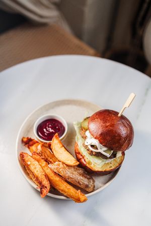 Truffle cheeseburger with brioche bun, pickles, iceberg, truffle mayo, f*cking fries, beetroot ketchup at Avit in Athens