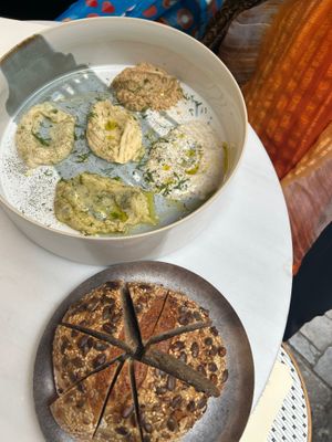 Gathering plate with different spreads and sourdough bread on the side  at Avit in Athens
