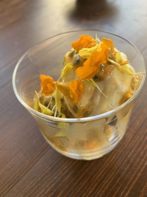 Homemade coconut ice cream (made with dry ice!) infused with pineapple and served with passion fruit and edible flowers... we felt like we were back in Hawaii!  at Avit in Athens