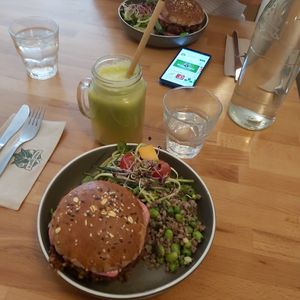 Home made burger which comes with a mix of salad, and a juice at la petite graine in Limoges