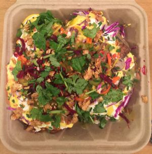 Papas Grande - 2 Large Organic Russets, Smokey Red Chili, NM green chili, Queso Vegano, Sour Cashew Cream, and all complementary toppings at Papas Hot Potatoes in Seattle