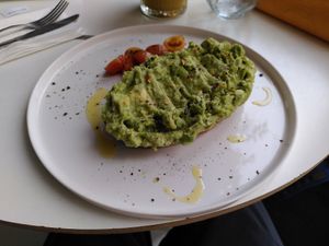 Full avocado toast with grilled tomatoes at Daily Poison in Vilnius