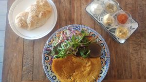 Lentil omelette with spreads and a bun. everything is made from scratch. at Shakti in Beer Sheva