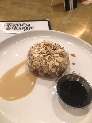 “Sweet Stuff” is a cake donut w/ toasted coconuts and almonds served with syrup at Modern Times Far West Lounge in Encinitas
