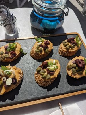 Bruschetta: Hummus | Hummus, olives, onion, capers at Galini Cafe in Santorini