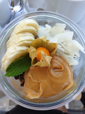 Porridge with dark chocolate granola, banana, and peanut butter at Galini Cafe in Santorini