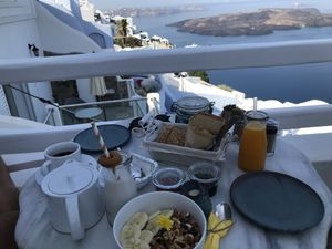 Vegan breakfast and a basket with pastries and bread.  at Galini Cafe in Santorini