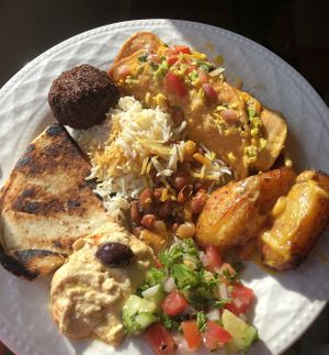 Loaded Taquito! Rice and beans! Plantains! Mediterranean Plate: falafel, pita, hummus!! Cucumber salad!!! at Arles and Boggs  in Wallingford