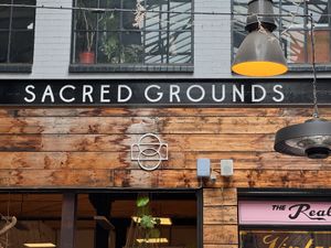 Restaurant sign at Sacred Grounds in Exeter