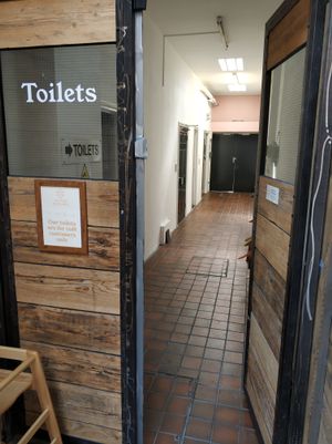 Toilets entrance at Sacred Grounds in Exeter