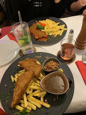Schnitzel with fries and curry sausage in the back  at V-Bandits in Ludwigsburg