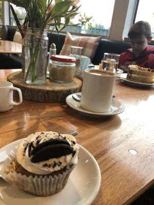 Oreo cupcake, Earl Grey soya milk tea and a Skittles cake in the background 💚 at The Ark in Northampton