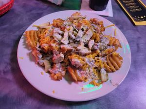 Vegan potato nachos (waffle fries, chick'n strips, melted cheeze, and vegan ranch dressing) at Big League Brews in Taylor