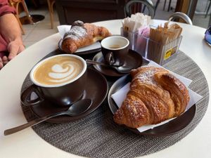 Cappuccino with soy milk and vegan croissants with chocolate and apricot jam at Café Maria Theresia in Merano