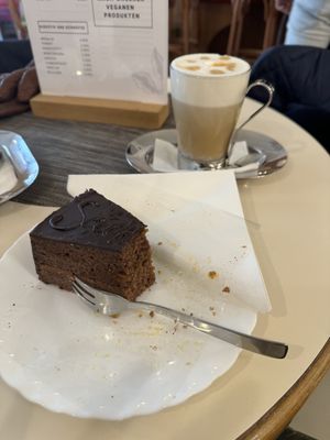 Vegane Sachertorte und Cappuccino mit Sojamilch  at Café Maria Theresia in Merano