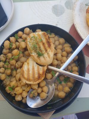 Delicious and comforting chickpea stew with perfectly toasted pitta  at Karma in Santorini