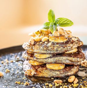 Banana oat pancake, walnuts and Greek honey.Freshly homemade breakfast and brunch from 8 am to 12 pm. at Karma in Santorini