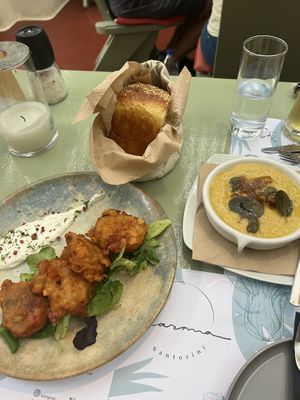 Tomatokeftedes fritters, fresh homemade bread, fava/yellow pea dip with caramelized onions  at Karma in Santorini