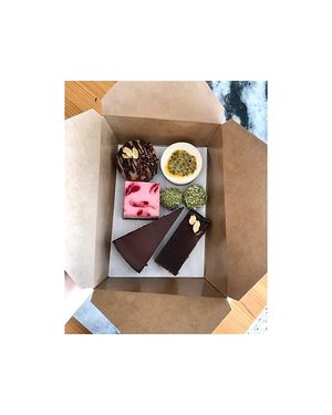 Box Of Happiness
hocolate Hazelnut Tart (1 Slice), Lemon Passion fruit Cheesecake (1 piece), Peanut Butter Banana Cheesecake (1 piece), SneakerZ Bar (1 piece), Matcha Truffles (2) at Seed of Happiness in Nicosia