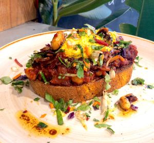 Toast of the day. Inspired by omelette & english breakfast. Mushrooms & chickpeas in rich tomato sauce with tofu cream, fresh herbs & spicy nuts oils on top at Beanuts - Pop Up in London