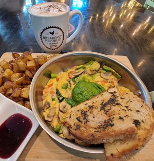 Veggie and Pesto Fritatta: open face omelet (Just Egg) with garlic, onion, bell pepper, mushrooms, spinach, sweet and sour tomato jam, and Pesto, served with herb-grilled sourdough at Breakfast Republic - East Village in San Diego