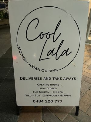 A-Frame sign on footpath; restaurant is off the street through the arcade and down some stairs at Cool Lala in Airlie Beach
