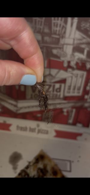 Hairball baked into pizza toppings 🤢  at Julien's in Millbrook