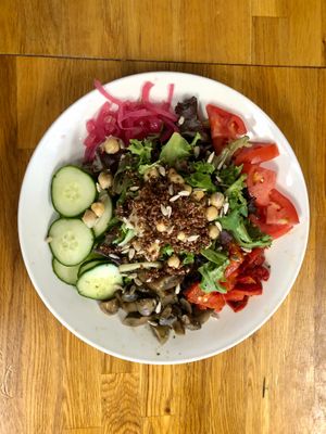 The Farmhouse Salad comes with mixed greens, pickled red onions, tomatoes, cucumbers, pesto marninated mushrooms, quinoa, chickpeas, roasted red peppers and lemon vinagarette. at Brunch in Conshohocken