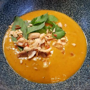 Take away - Red curry & smoked pumpkin soup, topped with roasted ginger/chili/garlic peanuts and fresh coriander & thai basil... It was as gorgeous as it looks 😍 at Bonboon in Amsterdam