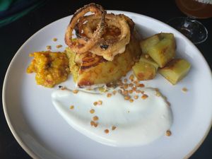 White cabbage | tikka masala | soya yoghurt with lime | coral lentils | onion tempura | sweet potato | date & mango chutney at Bonboon in Amsterdam