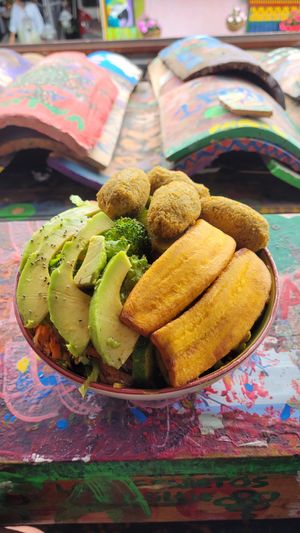 bowl with fried yuca balls, vegetables, bananas and salad at Namaste Vegan Food in Guatape