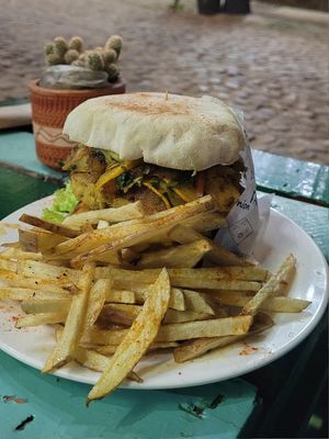 homemade fries and burgers with falafel patty and grilled vegetables at Namaste Vegan Food in Guatape