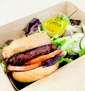 The Plant Burger: Vegan patty made in-house from lentils, mushrooms, beets, cashews, and bulgur wheat, topped with grilled onions, lettuce, tomato, and vegan aioli on an Acme bun  at The Plant Cafe Organic - Montgomery in San Francisco