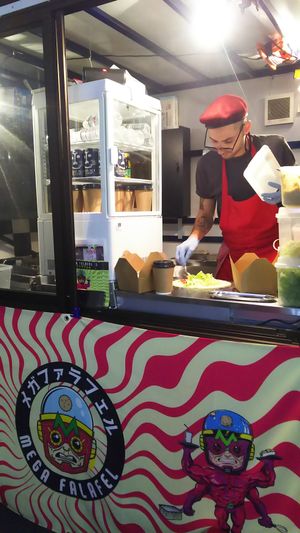 The cook making a falafel wrap at Mega Falafel in Tokyo