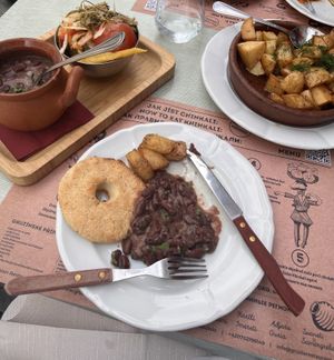 Bean stew, corn bread and pickled vegetables and a side of fried potatoes with dill  at Gruzie in Prague