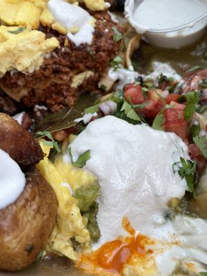 HUEVOS DIVORCIADOS (v) sunny side up eggs, house made vegan chorizo, avocado, 
 crema, queso fresco, black beans  Sooo good!  at Wooden Spoon in San Francisco