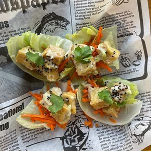 Tofu Sisig. A Fresh Vegan Take on a Filipino Classic: Crispy Protein-Rich Tofu, in a Tangy Creamy Vegan Garlic Mayo Sauce in Fresh Lettuce, Pickled Carrots, Sesame Seeds & Cilantro at Rustle & Still in Toronto