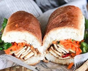 Tofu and baby bella mushroom sauteed in five spice sauce, with mushroom walnut pate. Served on Viet baguette with pickled carrots, cucumber, and cilantro. at Rustle & Still in Toronto