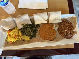 L-to-R: cabbage, kale, chickpeas, red lentils; all served on injera   at Zoma Ethiopian in Cleveland