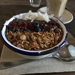 Superbowl food with a crispy granola, blueberries, chocolate, goji berries, chia seeds and coconut slices. at Distrikt Coffee in Berlin