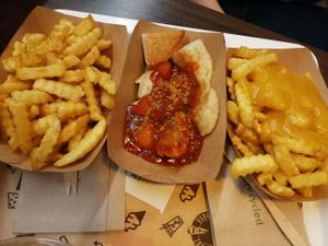 Patatas fritas, bratwurst y patatas con queso. Le pone curry a todo, demasiado curry para nuestro gusto. Si lo hubiéramos sabido pedíamos que no nos pusieran. 😵 at VINCENT - East Side Mall in Berlin