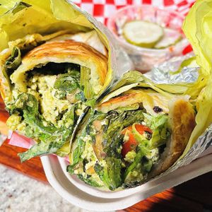 Pesto Tofu Scramble Wrap. Good flavors but it fell apart easily and was messy. (missing additional wrap that was ordered)  at Leo's Superfood Vegan Cafe in Northridge