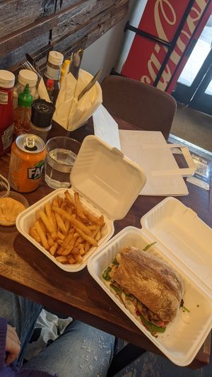 large vegan tempeh sandwich and salted chips with vegan mayo at Social Board in Brighton