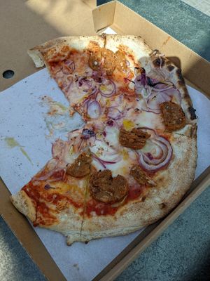 Tomato, vegan mozzarella, pizzarami vegan sausage, red onion at Hangin' Pizzeria in Betws-y-coed